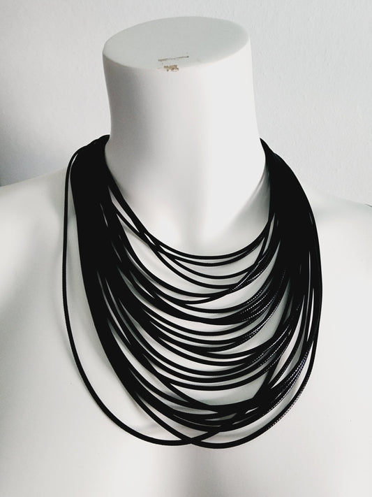 Pendant necklace with many leather strips Black