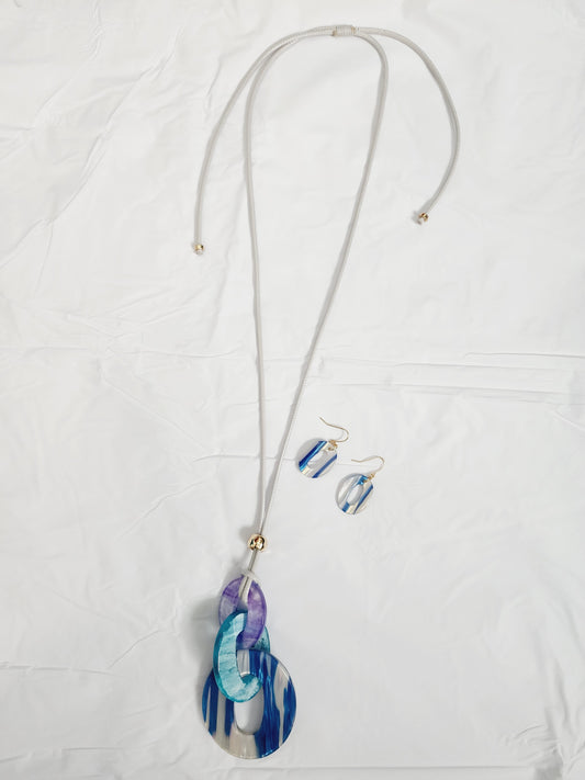 Set of earrings and long blue resin necklace